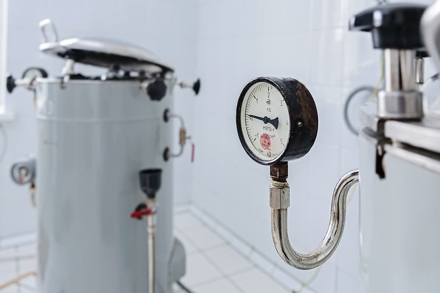 Vacuum type of autoclave with steam pressure gauge in focus 